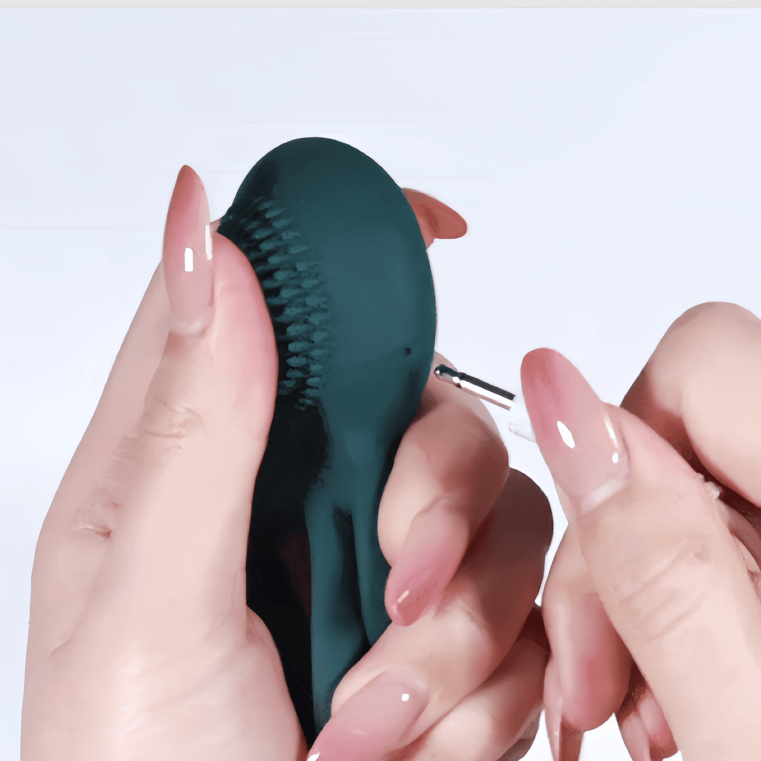 A close-up of the magnetic pinhole charging system. It quickly charges in 0.5 hours and supports up to 1 hour of continuous use.